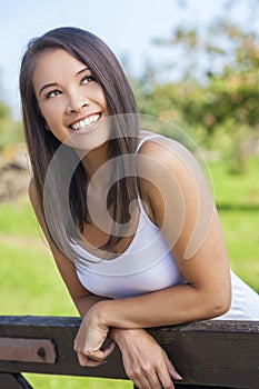 Beautiful Asian Eurasian Girl Resting on Fence