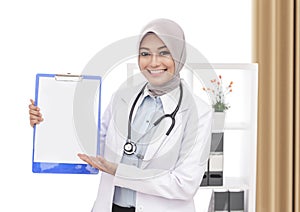 Beautiful asian female doctor with stethoscope presenting blank