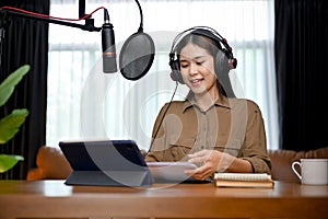 Beautiful Asian female online radio host reporting a daily morning news to her online followers