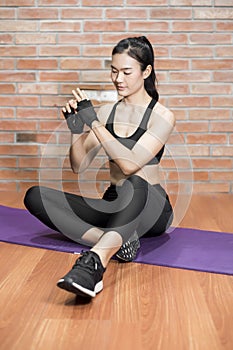 Beautiful asian fitnesses woman is exercise at home