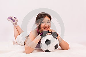 Beautiful Asian girl with a ball for playing football.