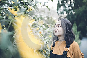 Beautiful asian girl in a garden, smiling