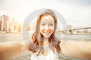 Beautiful asian girl holding the camera and taking self portrait in New york