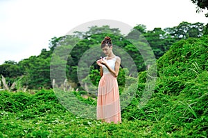 Beautiful asian girl playing in the grass photo