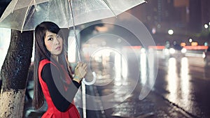 Beautiful Asian girl riding a bus in the middle of the rain