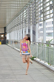 Beautiful Asian girl showing youthful vigor on the pedestrian bridge