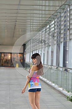 Beautiful Asian girl showing youthful vigor on the pedestrian bridge