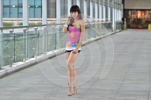 Beautiful Asian girl showing youthful vigor on the pedestrian bridge