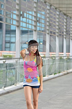 Beautiful Asian girl showing youthful vigor on the pedestrian bridge