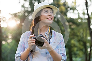 Beautiful asian girl smiling with digital camera photographing,