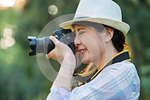 Beautiful asian girl smiling with digital camera photographing,