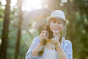 Beautiful asian girl smiling with digital camera photographing,