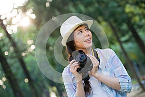 Beautiful asian girl smiling with digital camera photographing,