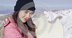 Beautiful asian girl with snowboard