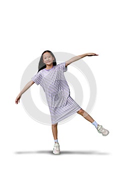 Beautiful Asian girl stand on one leg and arms outstretched on white background. Full body image with clipping path
