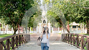 Beautiful Asian girl taking pictures on bidge , Temple background