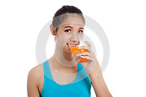 Beautiful Asian healthy girl drinking orange juice