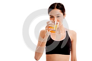 Beautiful Asian healthy girl drinking orange juice