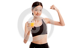 Beautiful Asian healthy girl drinking orange juice flexing bi