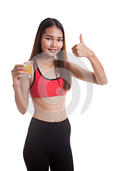 Beautiful Asian healthy girl drinking orange juice thumbs up.