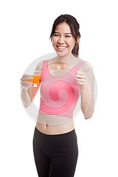 Beautiful Asian healthy girl drinking orange juice thumbs up.