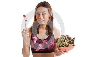 Beautiful Asian healthy girl enjoy eating salad.