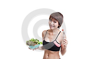 Beautiful Asian healthy girl enjoy eating salad.