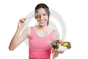 Beautiful Asian healthy girl enjoy eating salad.