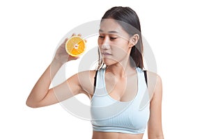 Beautiful Asian healthy girl with orange fruit licks her lips.