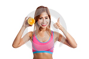 Beautiful Asian healthy girl thumbs up with orange fruit