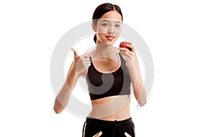 Beautiful Asian healthy girl thumbs up with red apple
