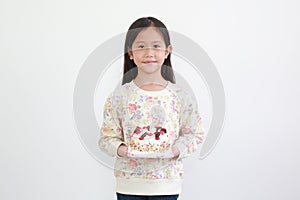 Beautiful asian little kid girl holding happy birthday cake on white background