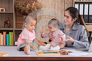 Beautiful Asian mother confuse multi task, single mom cannot work while kids playing, work from home fussy taking care chaotic