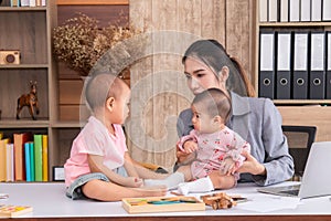 Beautiful Asian mother confuse multi task, single mom cannot work while kids playing, work from home fussy taking care chaotic