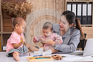 Beautiful Asian mother confuse multi task, single mom cannot work while kids playing, work from home fussy taking care chaotic