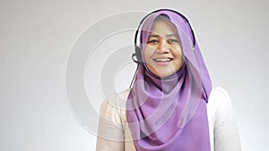 Beautiful Asian muslim lady call center customer service operator talking and smiling
