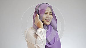 Beautiful Asian muslim lady call center customer service operator talking and smiling