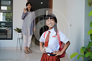 beautiful asian primary student going to school in the morning