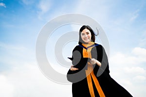 Beautiful asian university or college graduate student woman smiling in graduation academic dress or gown, education or success co photo