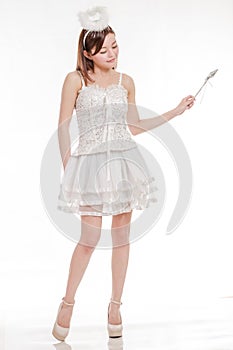 Beautiful Asian Woman in Angel Costume waving wand