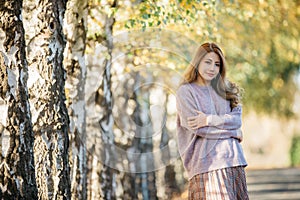 Beautiful asian woman with autumn leaves, flower and fall yellow leaves background at  Christchruch, New Zealand