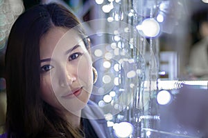 Beautiful Asian woman on a background with bokeh color lights,Blurry lights effect