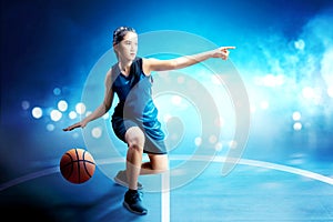 Beautiful asian woman in basketball uniform dribbling the ball