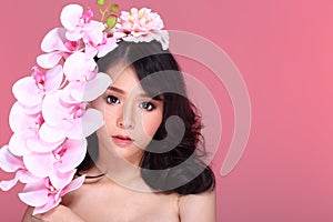 Beautiful Asian Woman black hair with flora crowd, holding bouquet artificial rose over chest