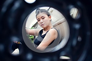 Beautiful asian woman with blur foreground of car& x27;s wheel