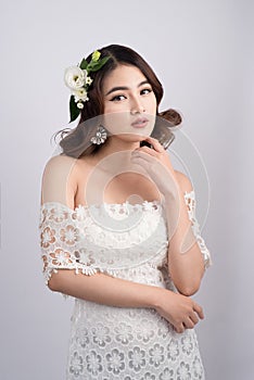 Beautiful asian woman bride on grey background. Closeup portrait