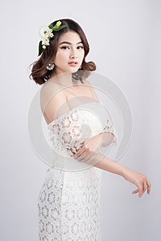 Beautiful asian woman bride on grey background. Closeup portrait