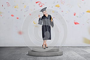 Beautiful asian woman celebrate her graduation with cap and diploma scroll