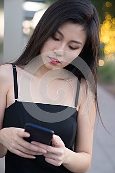 Beautiful Asian woman checking her text messages