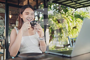 Beautiful asian woman with digital laptop computer happy and relax at coffee shop.